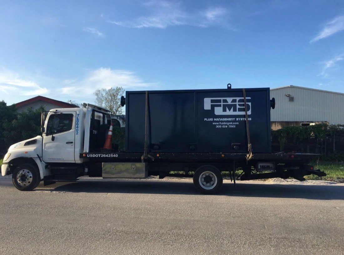 FMS sediment tank loaded on a flatbed truck for delivery